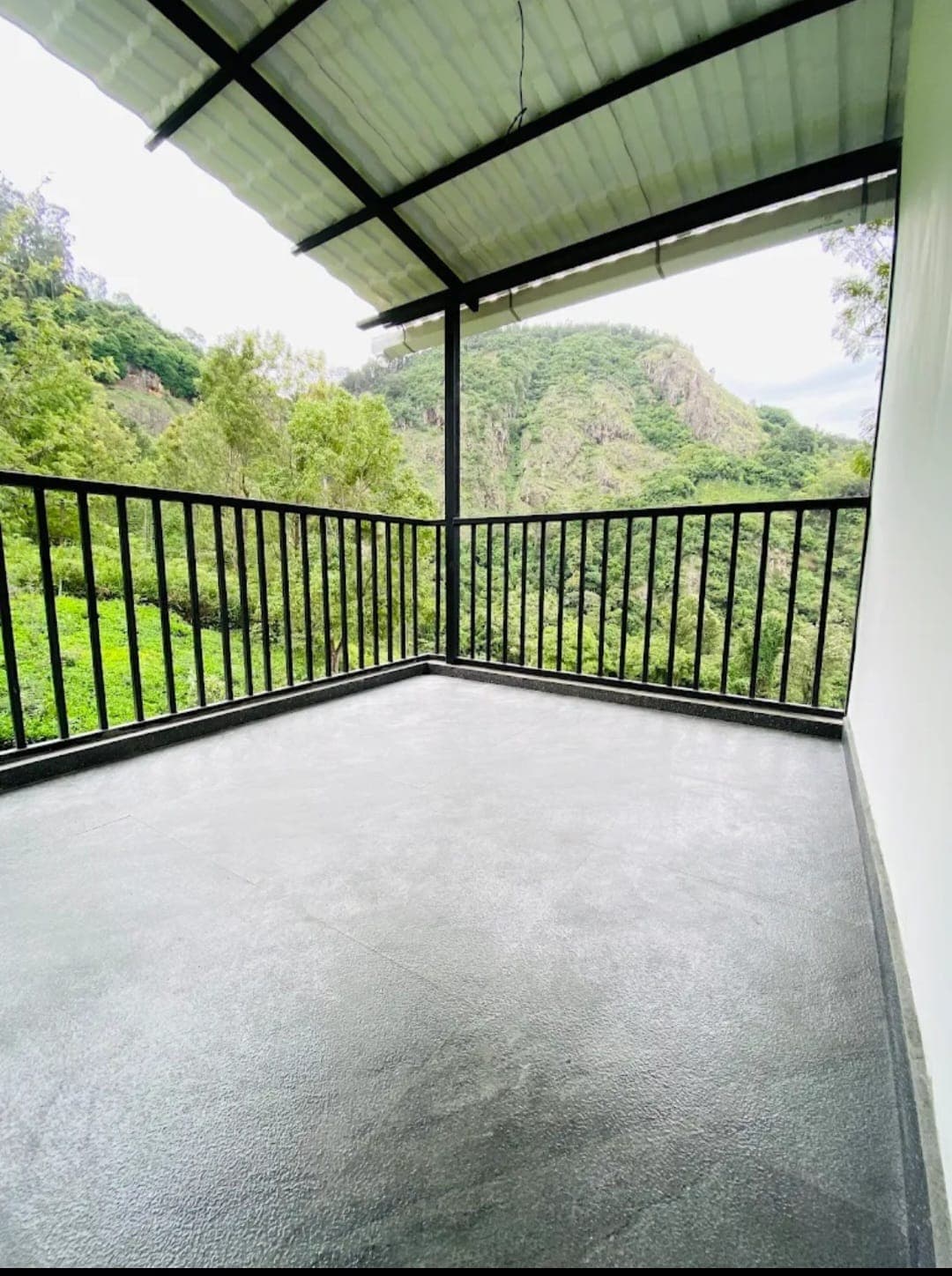 Covered balcony overlooking the green hillside